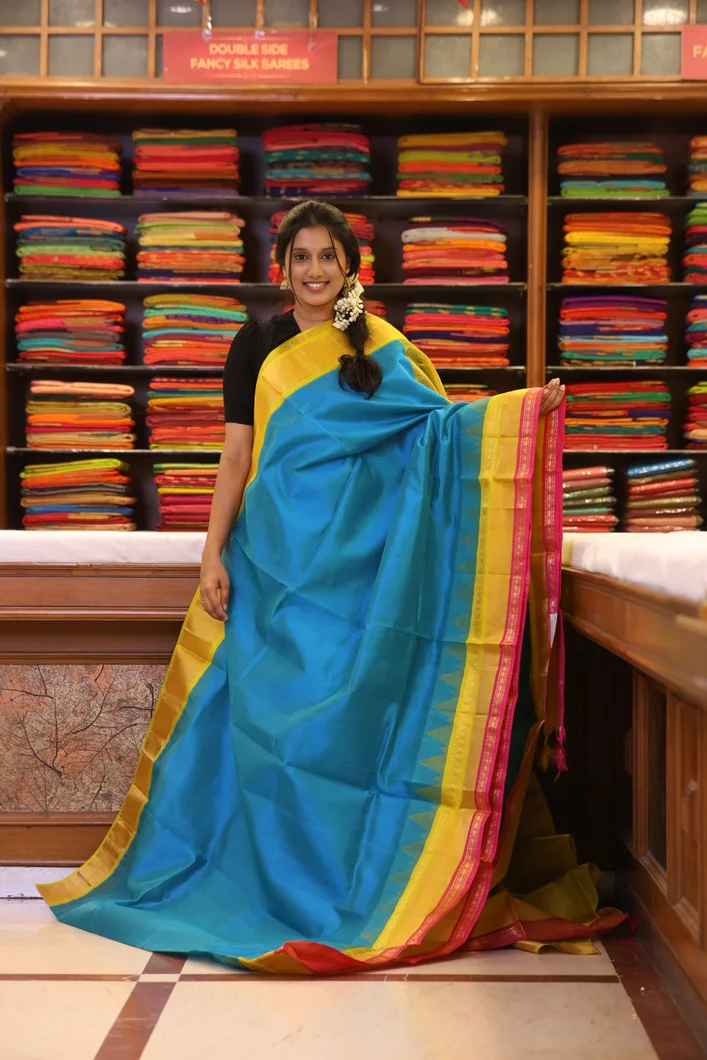 silk-cotton-peacock-blue-saree-with-yellow-pink-rettai-pettu-border-sw000001673-a
