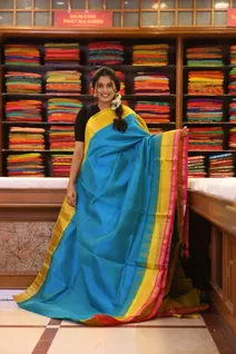 silk-cotton-peacock-blue-saree-with-yellow-pink-rettai-pettu-border-sw000001673-a